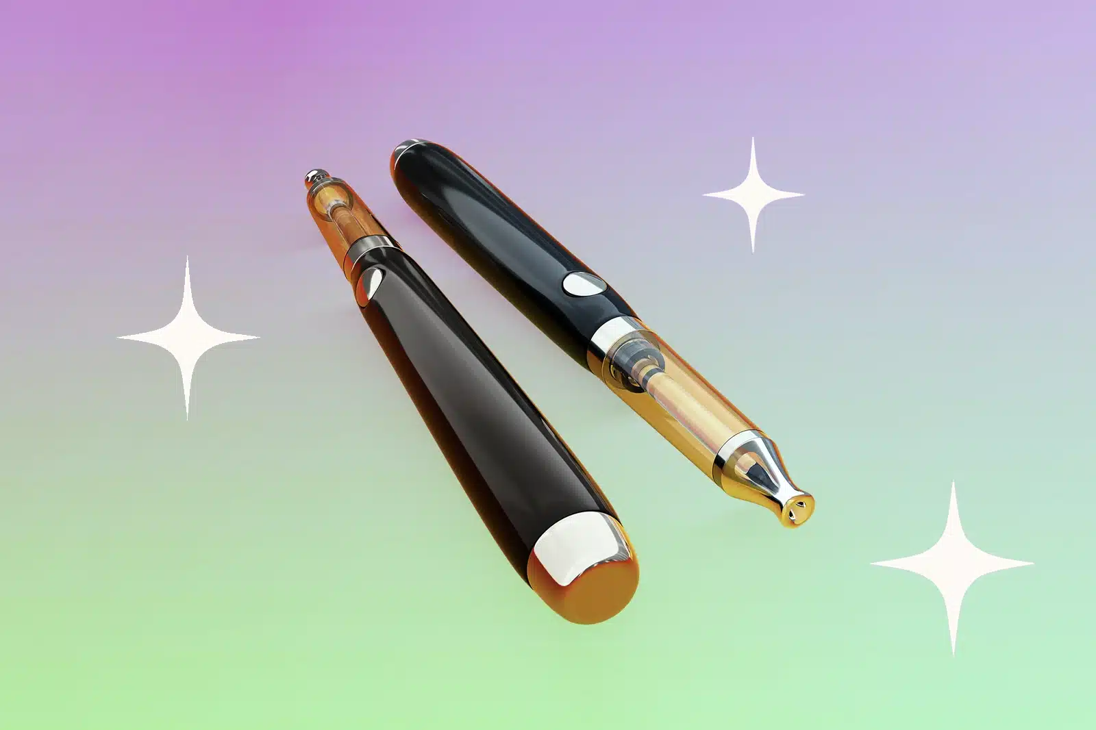 Two black and gold vape pens are placed against a multicoloured background